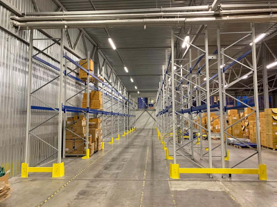 A team of workers installing shelving units in a warehouse.